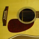 Bridge A closeup of the top. Note the Brazilian Rosewood bridge, tortoise pickguard, and mother of pearl soundhole decoration.