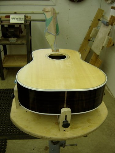 Guitar in holder for cleaning