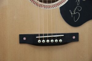 The ebony pickguard with etched baseball inlays.