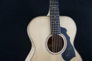 The baseball rosette. Inlaid in flamed maple in the spruce top.